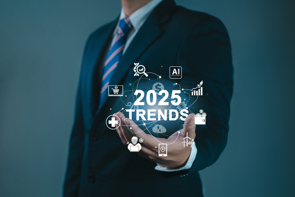 A professional holding virtual icons for trending business topics in 2025.