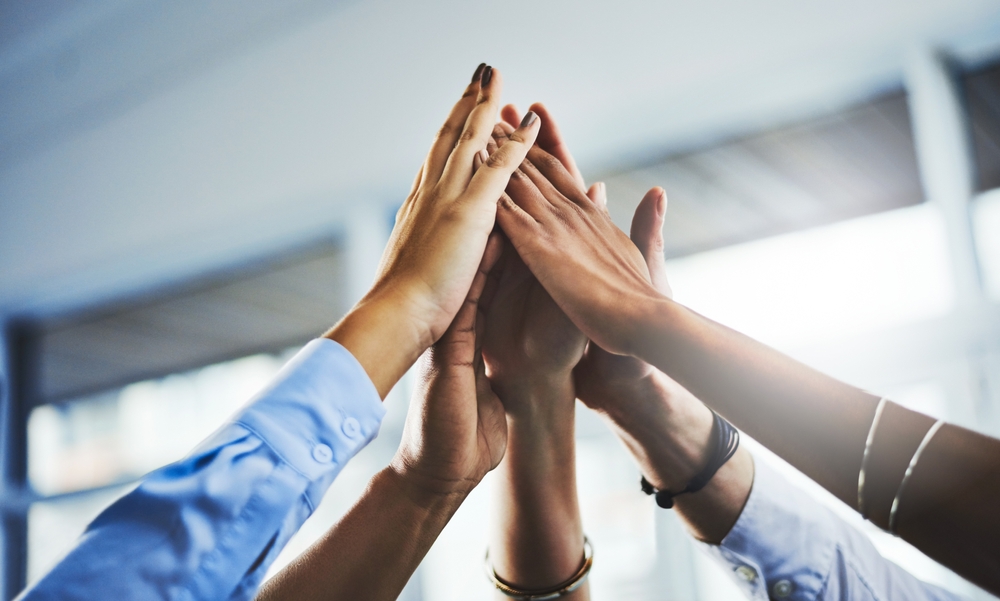 A M&A team high fives.